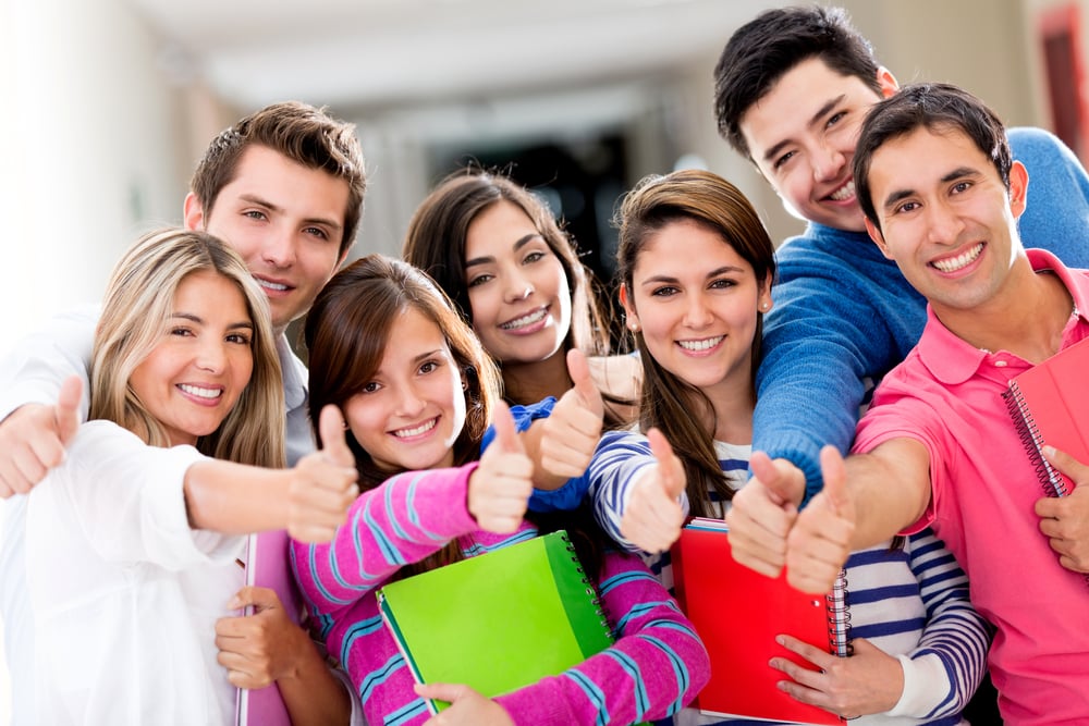 Happy group of students with thumbs up